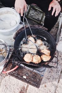 High angle view of person preparing food on barbecue grill