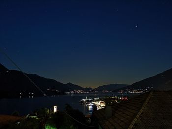 Illuminated city against sky at night