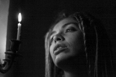 Portrait of woman against black background