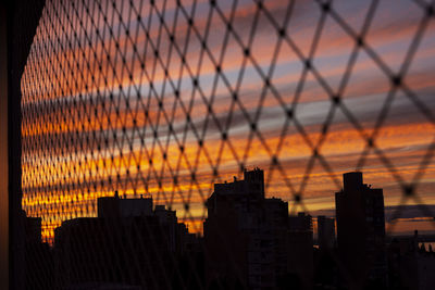 Silhouette buildings against sky during sunset