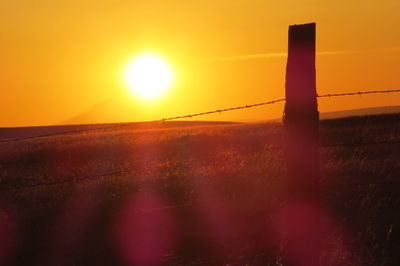 Sunset seen through chainlink fence