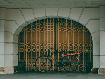 Bicycle parked against wall in building