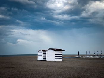 Storm clouds over two wooden houses on the beach