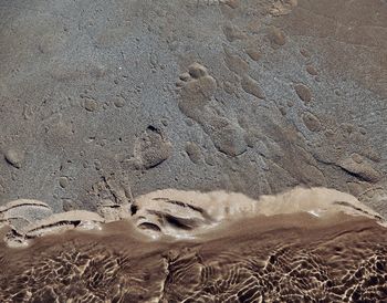 High angle view of footprints on sand