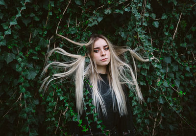 Portrait of beautiful young woman in forest