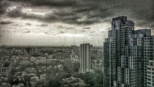 Cityscape against cloudy sky