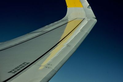 Low angle view of yellow flag against clear sky