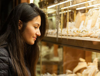 Woman looking at jewelry in store