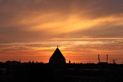 Built structure against sky at sunset