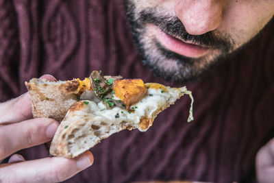 Midsection of man having pizza