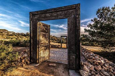 Old ruin on field against sky