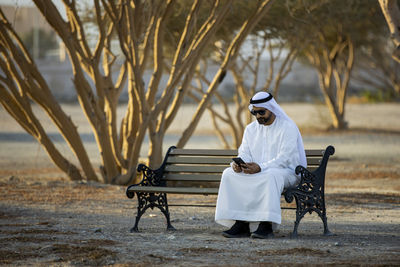 Rear view of man sitting on bench