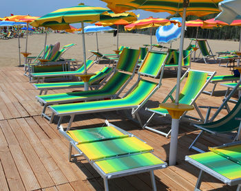 Empty chairs and tables in swimming pool