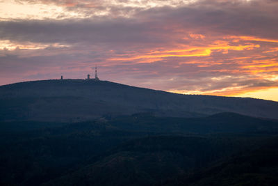 Scenic view of silhouette mountains against sky at sunset