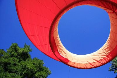 Low angle view of hot air balloon against clear blue sky