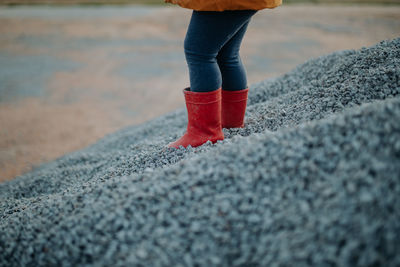 Child with red rubber boots
