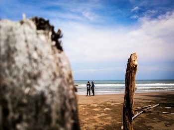 People on beach against sky