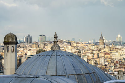 Buildings in city against sky