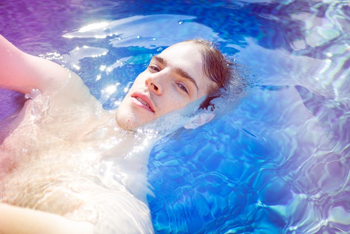 lifestyles, water, leisure activity, swimming pool, person, blue, young adult, vacations, enjoyment, sea, young women, refreshment, swimming, high angle view, relaxation, portrait, looking at camera, summer