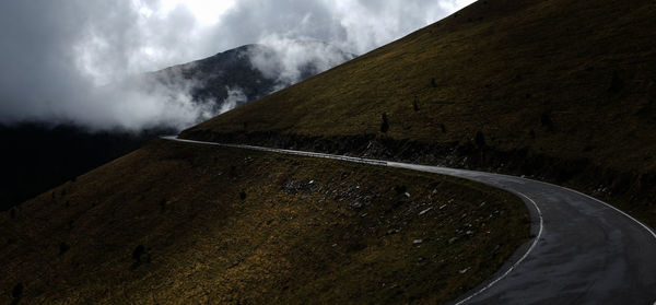 Diminishing perspective of mountain road against sky