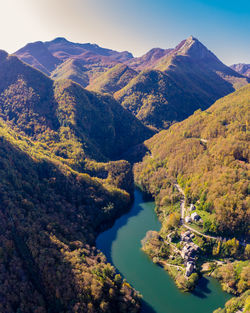 High angle view of river amidst mountains against sky