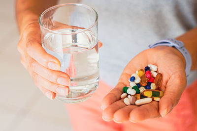 Cropped hand of woman holding drink
