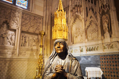 Low angle view of statue against temple building