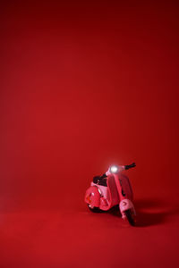 Close-up of toy car against red background