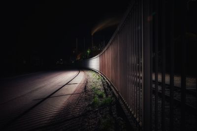 View of bridge over road at night