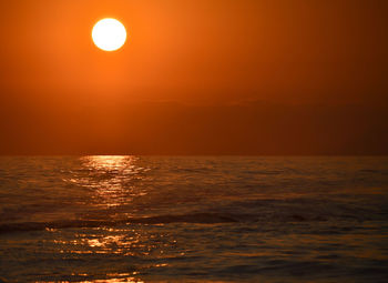 Scenic view of sea against orange sky