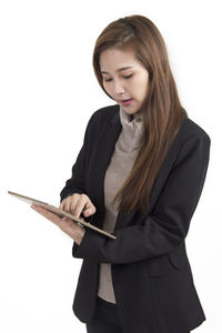 Young woman using smart phone against white background