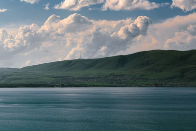 Scenic view of sea and mountains against sky