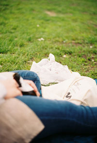 Low section of woman lying on grass