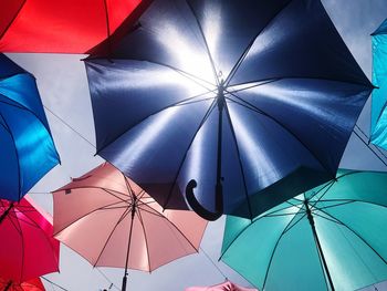 Low angle view of umbrellas against sky in market