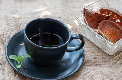 High angle view of coffee and cups on table