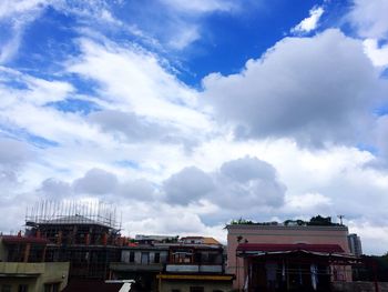 Low angle view of building against cloudy sky