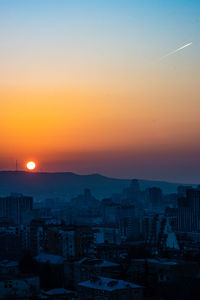 High angle view of buildings against sky during sunset