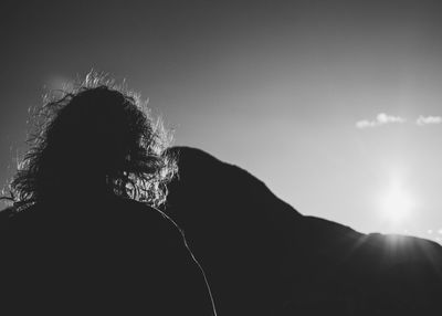 Rear view of silhouette woman against sky