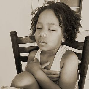 Portrait of boy sitting on chair at home