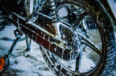 Close-up of motorcycle covered with soap sud 