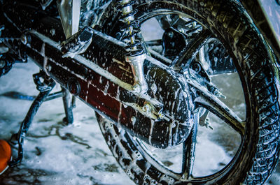 Close-up of motorcycle covered with soap sud 