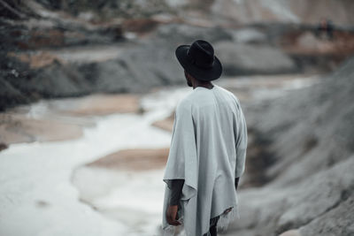 Rear view of man standing on snow