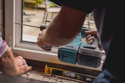 Midsection of man repairing car