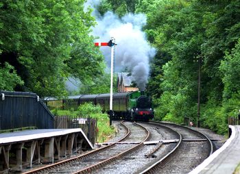 Train on railroad tracks against sky