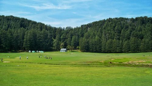 Scenic view of golf course against sky