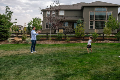 Father and son playing catch in the backyard
