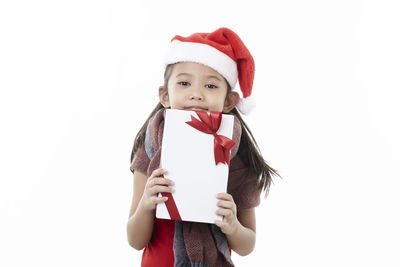 Portrait of girl holding umbrella against white background