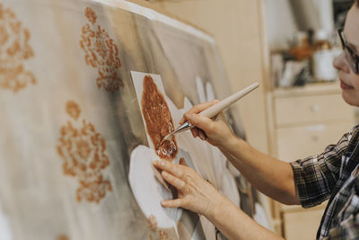 Artist painting in studio