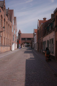 Street amidst buildings against sky