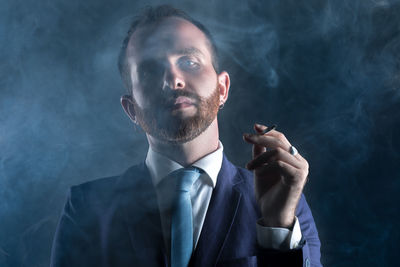 Portrait of man smoking cigarette